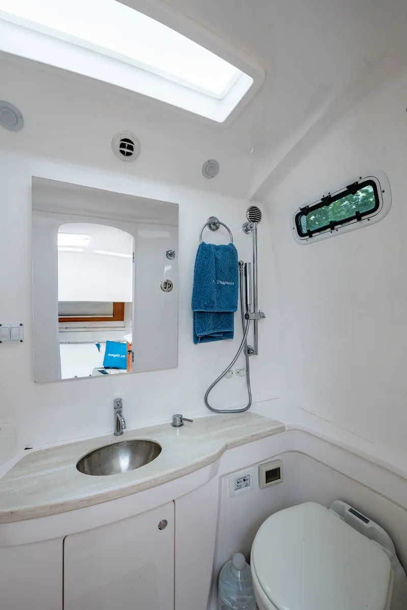 Slide: The Image of Bathroom interior of 2020 Intrepid 407 Panacea boat, featuring sink, mirror, and shower. - 34