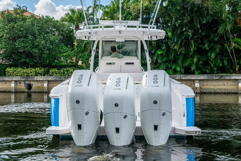 Slide: The Image of 2020 Intrepid 407 Panacea boat with triple 400 horsepower engines on a calm waterway. - 36