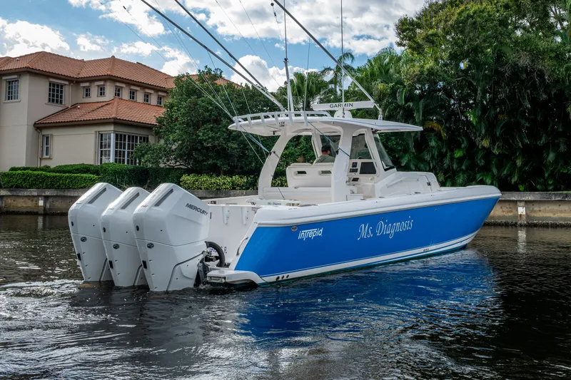 Slide: The Image of 2020 Intrepid 407 Panacea boat with triple Mercury engines on a scenic waterway. - 37
