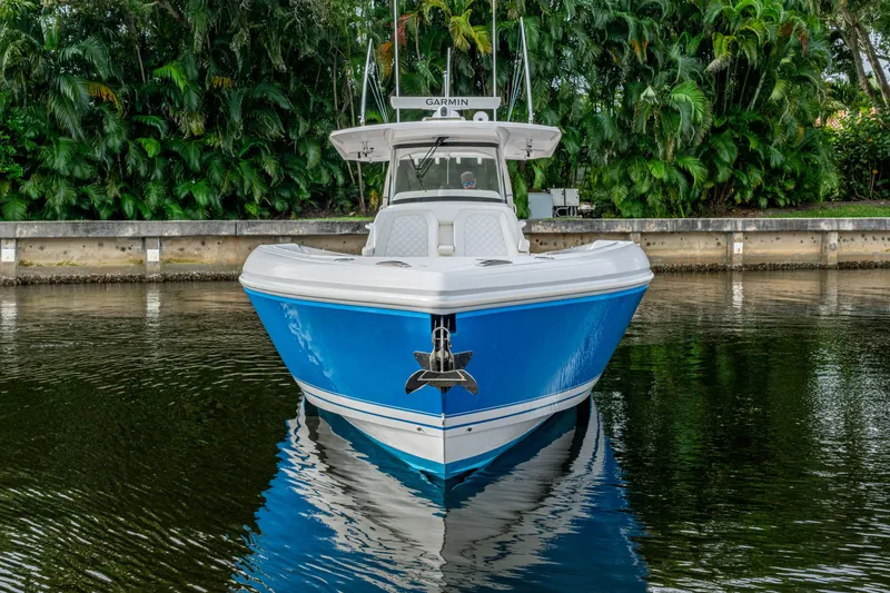 Slide: The Image of 2020 Intrepid 407 Panacea boat on calm water, surrounded by lush greenery. - 42