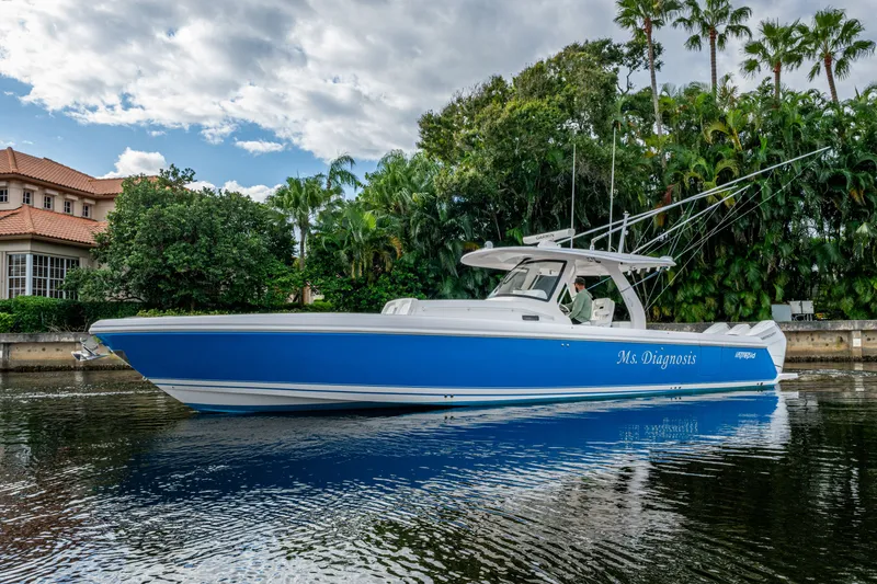 Slide: The Image of 2020 Intrepid 407 Panacea boat on calm water, surrounded by lush greenery. - 43