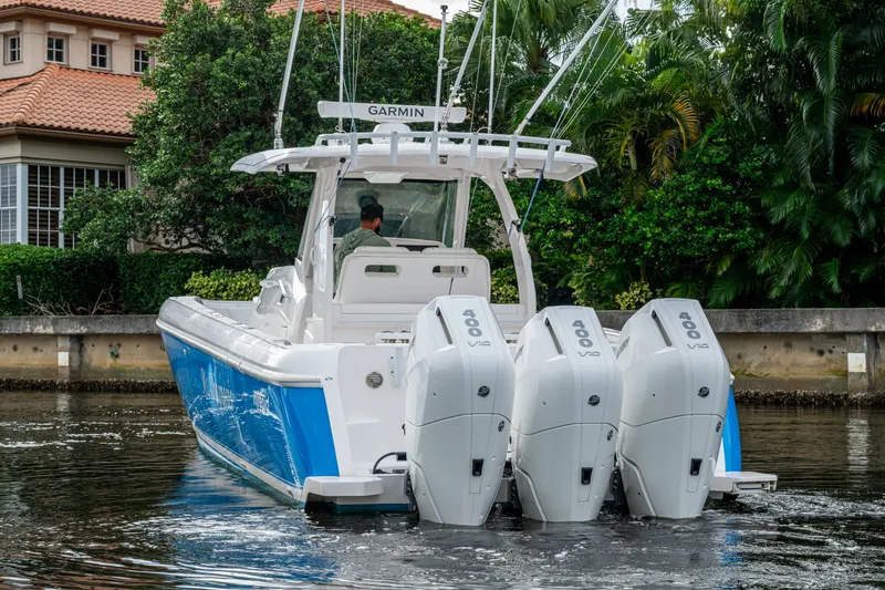 Slide: The Image of 2020 Intrepid 407 Panacea boat with triple 400 horsepower engines on a calm waterway. - 47