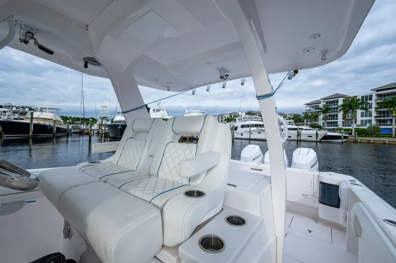 Slide: The Image of Luxury seating on a 2020 Intrepid 407 Panacea boat docked at a marina. - 7