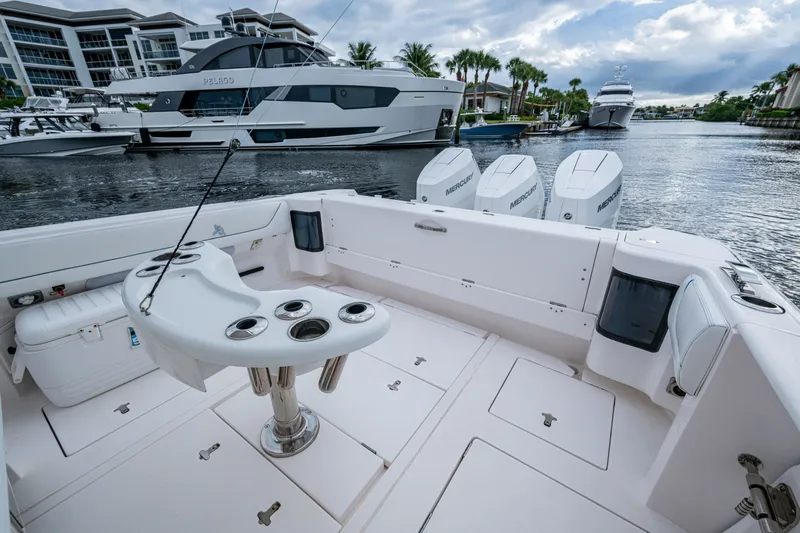 Slide: The Image of 2020 Intrepid 407 Panacea boat with fishing rod holders and Mercury engines docked in marina. - 9