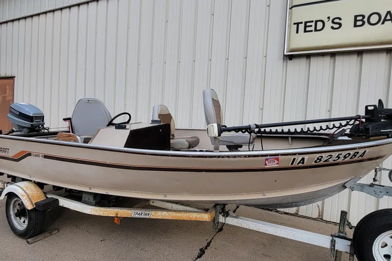 Slide: The Image of 1987 Alumacraft Classic 165 CS boat on trailer, parked outside Ted's Boats. - 7