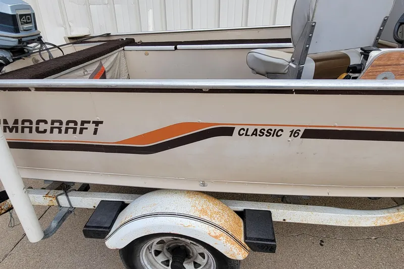 Slide: The Image of 1987 Alumacraft Classic 165 CS boat on trailer, featuring vintage design and outboard motor. - 8