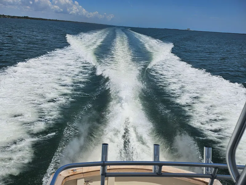 Slide: The Image of Wake of a 1991 Donzi 65 Sportfisherman boat on open water. - 20