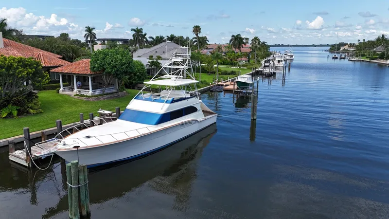 Slide: The Image of 1991 Donzi 65 Sportfisherman yacht docked in a scenic residential canal. - 29