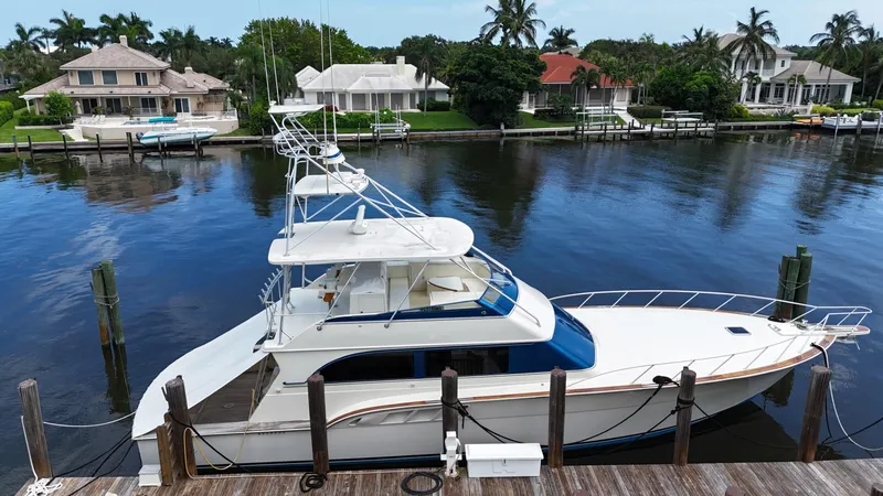 Slide: The Image of 1991 Donzi 65 Sportfisherman yacht docked in a scenic waterfront neighborhood. - 32