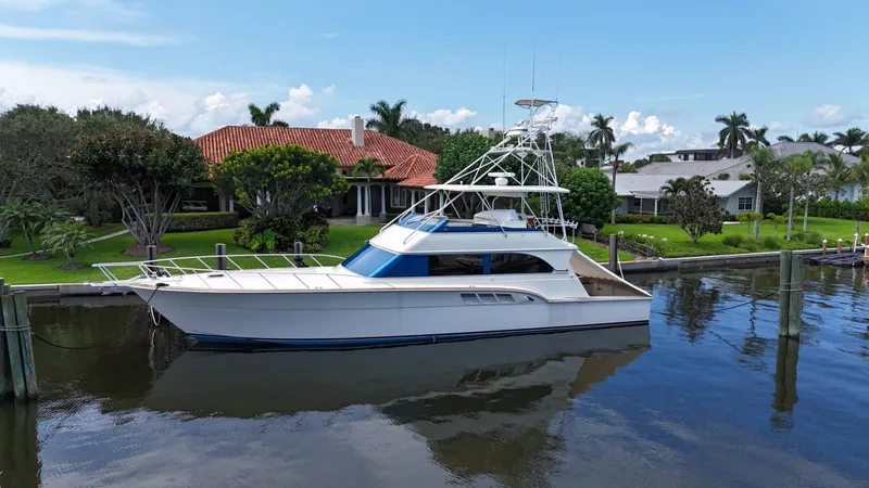 Slide: The Image of 1991 Donzi 65 Sportfisherman yacht docked near waterfront homes. - 34