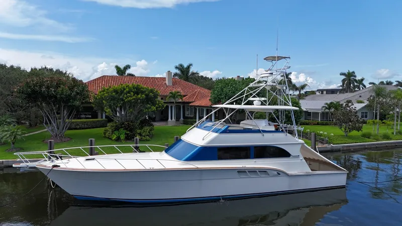 Slide: The Image of 1991 Donzi 65 Sportfisherman yacht docked near waterfront homes. - 35