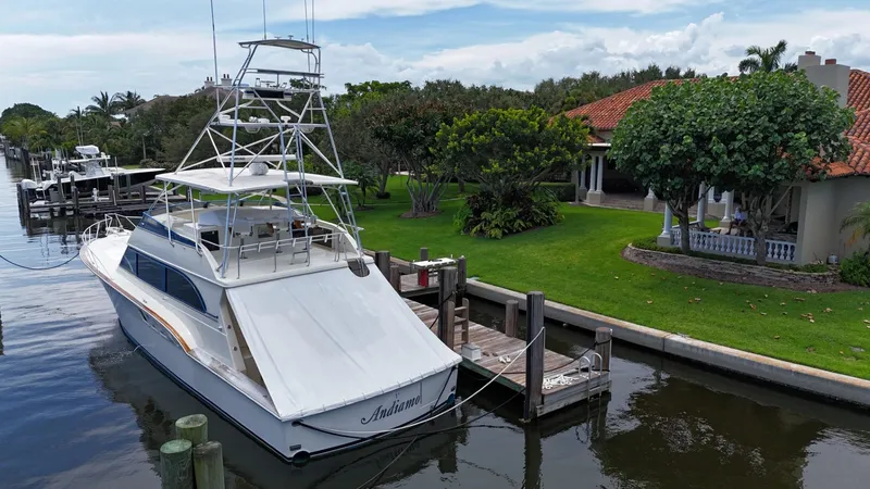 Slide: The Image of 1991 Donzi 65 Sportfisherman yacht docked by a waterfront home. - 37