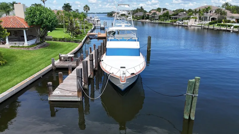 Slide: The Image of 1991 Donzi 65 Sportfisherman docked in a scenic canal. - 39