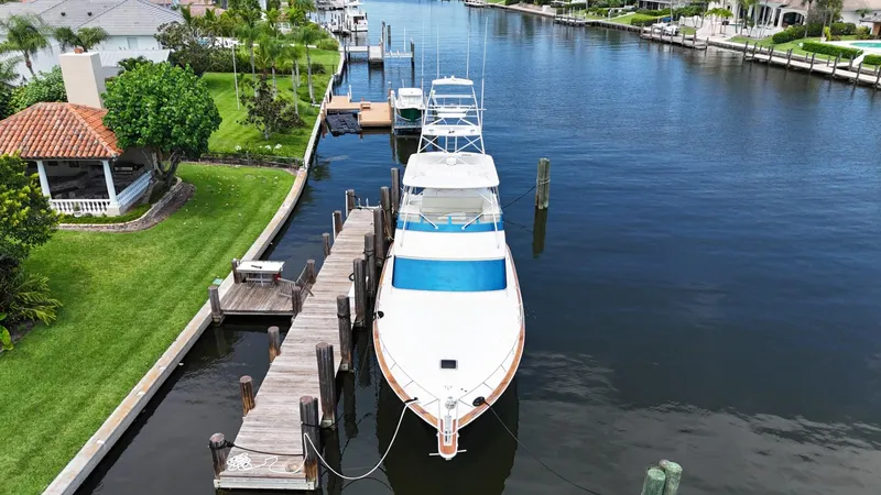 Slide: The Image of 1991 Donzi 65 Sportfisherman docked in a serene canal. - 40