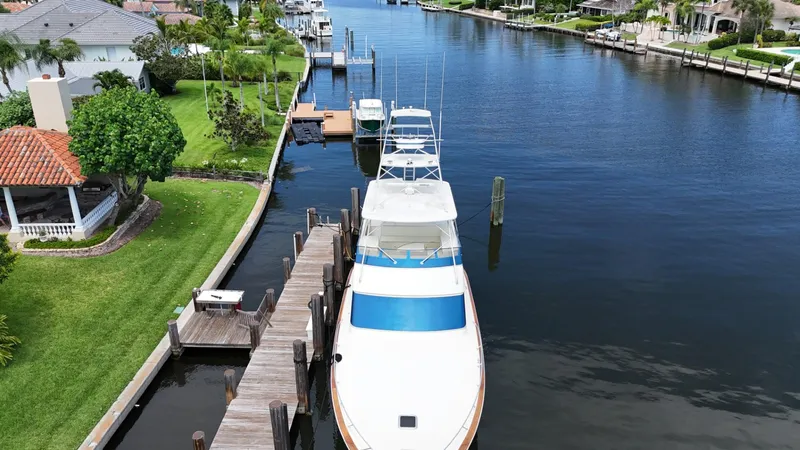 Slide: The Image of 1991 Donzi 65 Sportfisherman docked in a scenic canal with waterfront homes. - 41