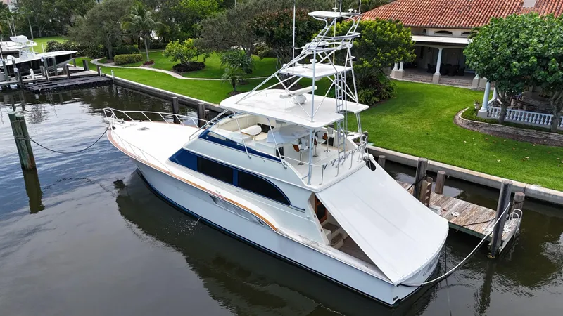 Slide: The Image of 1991 Donzi 65 Sportfisherman yacht docked by a waterfront property. - 42