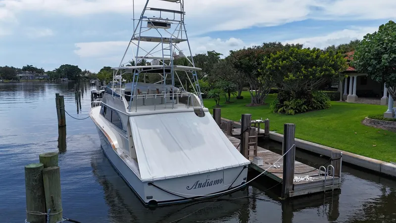 Slide: The Image of 1991 Donzi 65 Sportfisherman yacht docked by a lush waterfront property. - 43