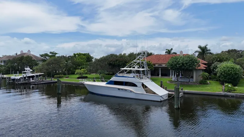 Slide: The Image of 1991 Donzi 65 Sportfisherman yacht docked near waterfront property. - 45