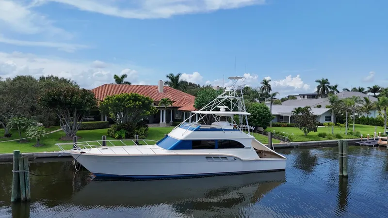 Slide: The Image of 1991 Donzi 65 Sportfisherman yacht docked by waterfront homes. - 46