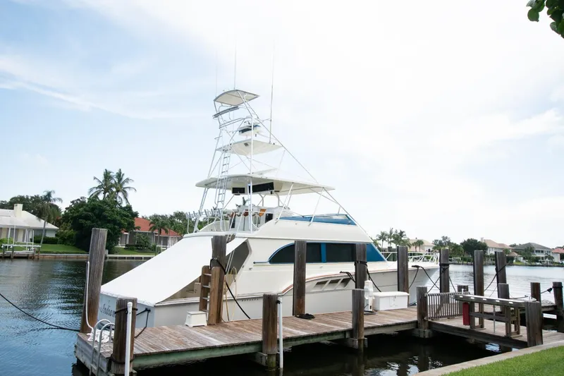 Slide: The Image of 1991 Donzi 65 Sportfisherman yacht docked at a marina. - 49