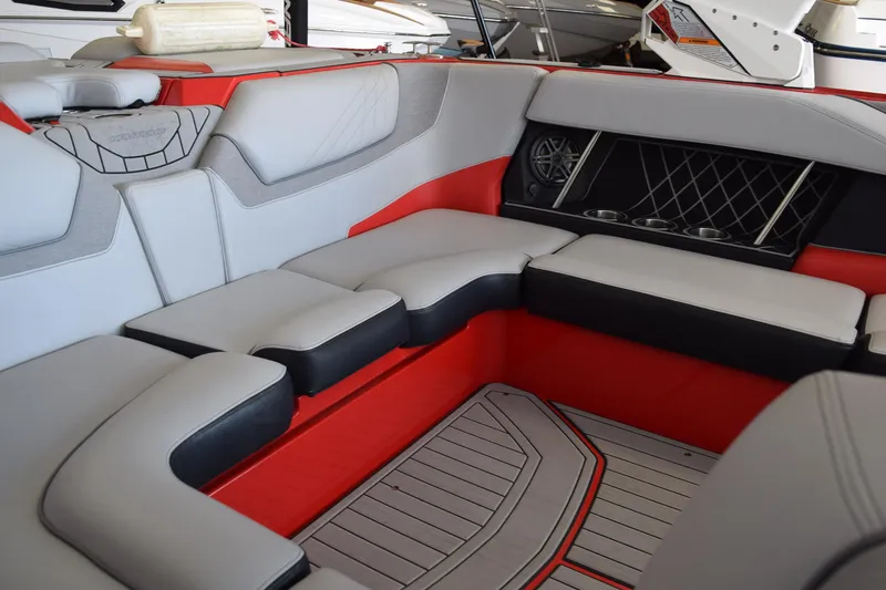 Slide: The Image of Interior of 2021 Nautique Super Air Nautique GS22, featuring stylish seating and cup holders. - 10