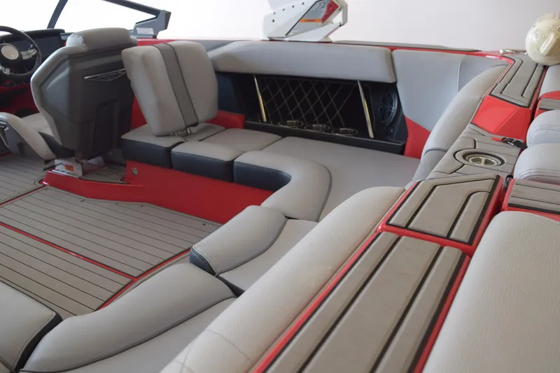 Slide: The Image of 2021 Nautique Super Air Nautique GS22 interior with red and gray seating. - 11