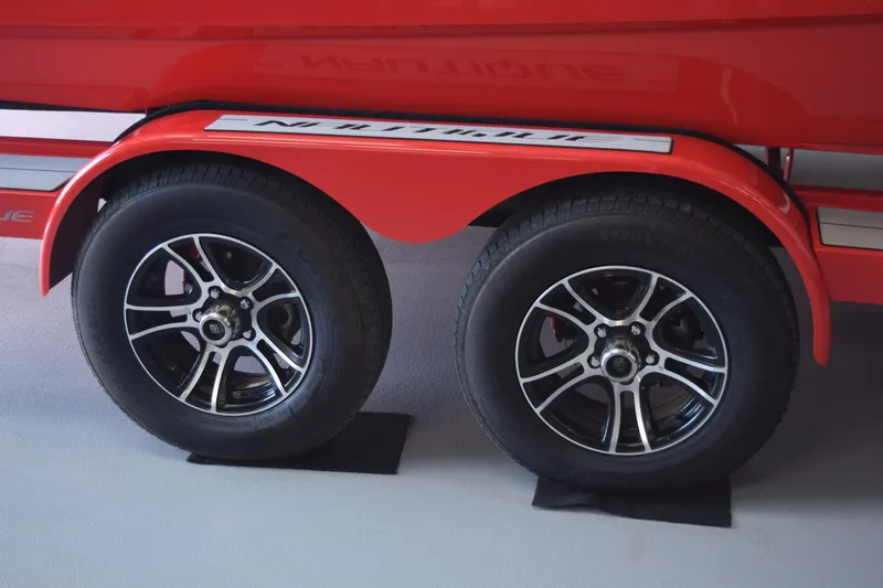 Slide: The Image of 2021 Nautique Super Air Nautique GS22 trailer with dual black alloy wheels. - 13