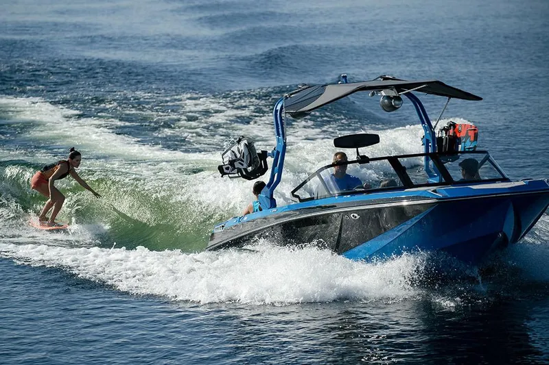 Slide: The Image of Manufacturer Provided Image: 2021 Nautique Super Air Nautique GS22 towing a wakeboarder on a lake. - 17