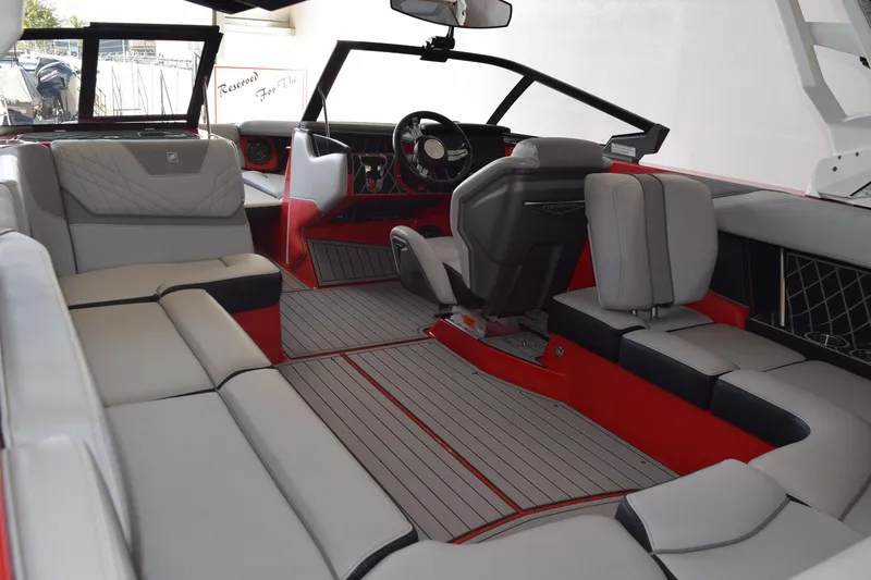 Slide: The Image of 2021 Nautique Super Air Nautique GS22 interior with luxurious seating and modern dashboard design. - 6