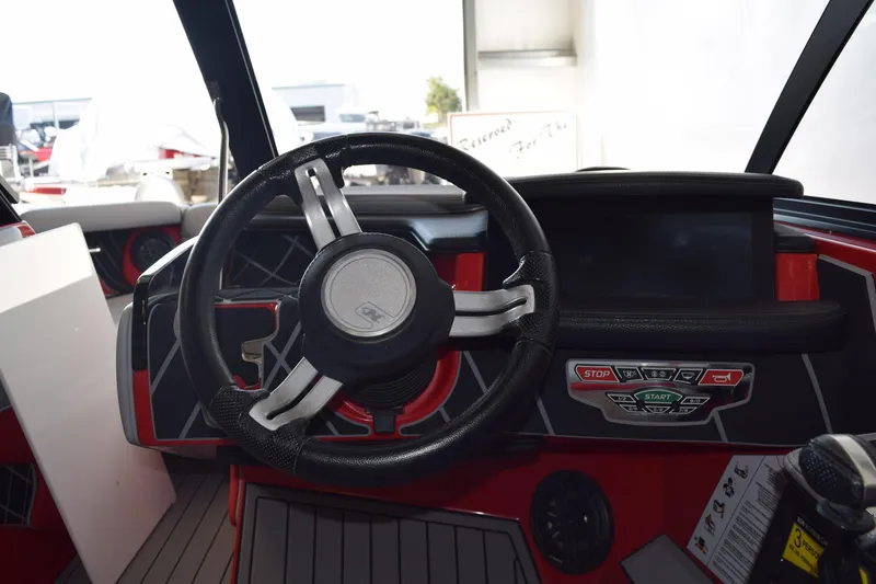 Slide: The Image of 2021 Nautique Super Air Nautique GS22 dashboard with steering wheel and control panel. - 8