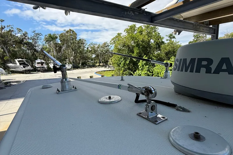 Slide: The Image of 2008 Century 2901 Center Console boat with Simrad equipment, docked near trees and other boats. - 22