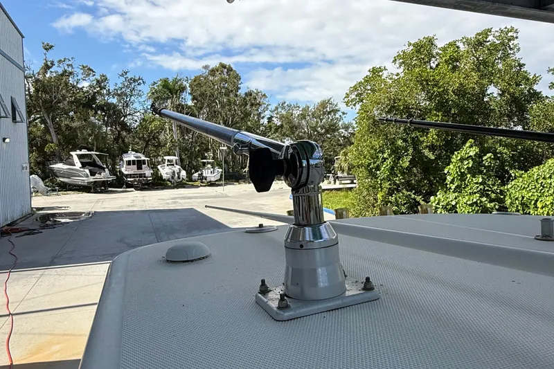 Slide: The Image of 2008 Century 2901 Center Console boat with mounted fishing rod holder, docked near trees. - 25