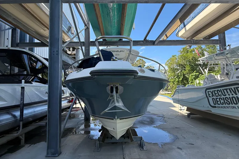 Slide: The Image of 2008 Century 2901 Center Console boat in storage, surrounded by other boats. - 3