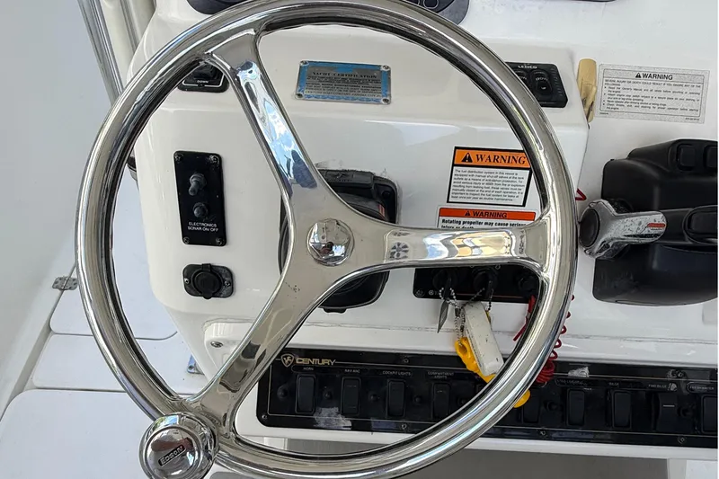 Slide: The Image of Steering wheel and controls of a 2008 Century 2901 Center Console boat. - 37