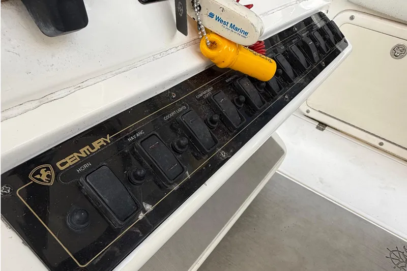 Slide: The Image of Century 2901 Center Console 2008 dashboard with control switches and West Marine keychain. - 38