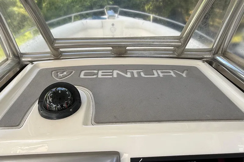 Slide: The Image of 2008 Century 2901 Center Console boat dashboard with compass and logo. - 42