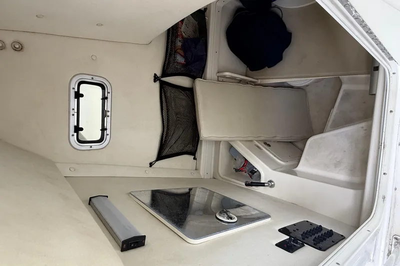 Slide: The Image of Interior cabin of a 2008 Century 2901 Center Console boat, featuring seating and storage. - 46