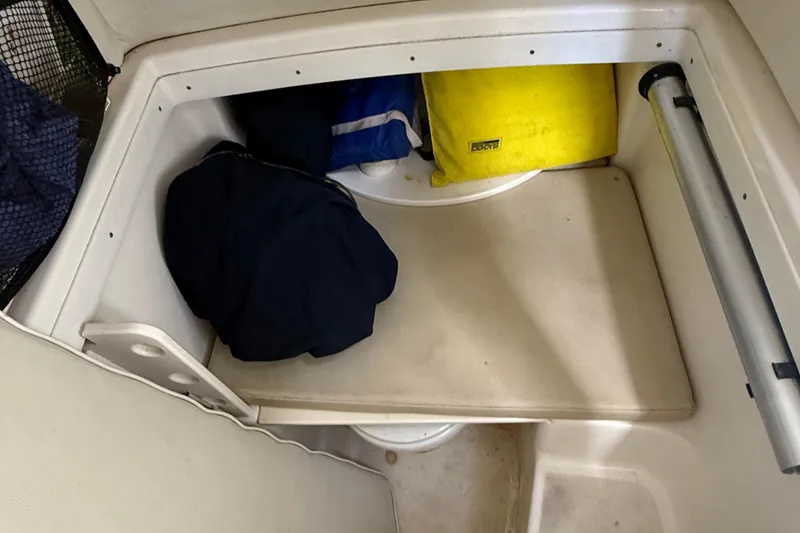 Slide: The Image of Storage compartment in a 2008 Century 2901 Center Console boat with gear and equipment. - 48