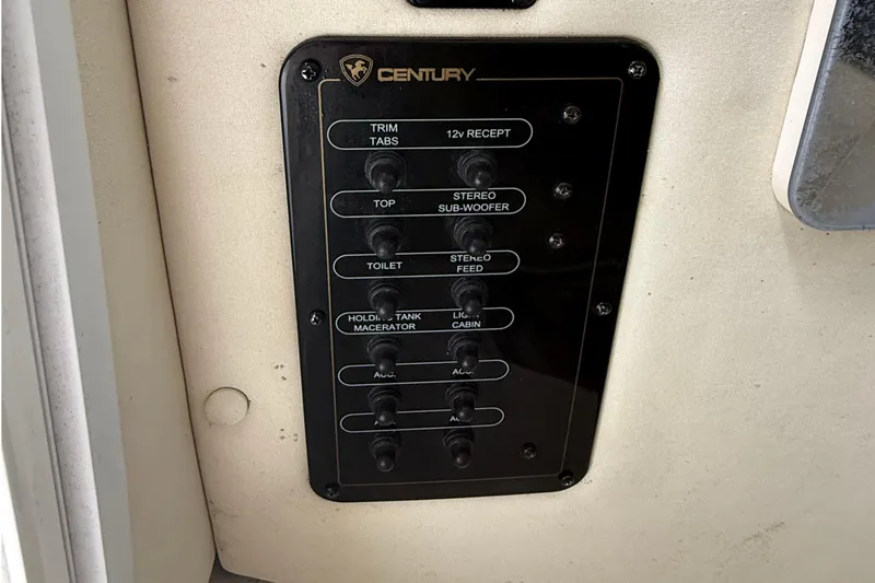 Slide: The Image of Control panel of a 2008 Century 2901 Center Console boat with labeled switches. - 49