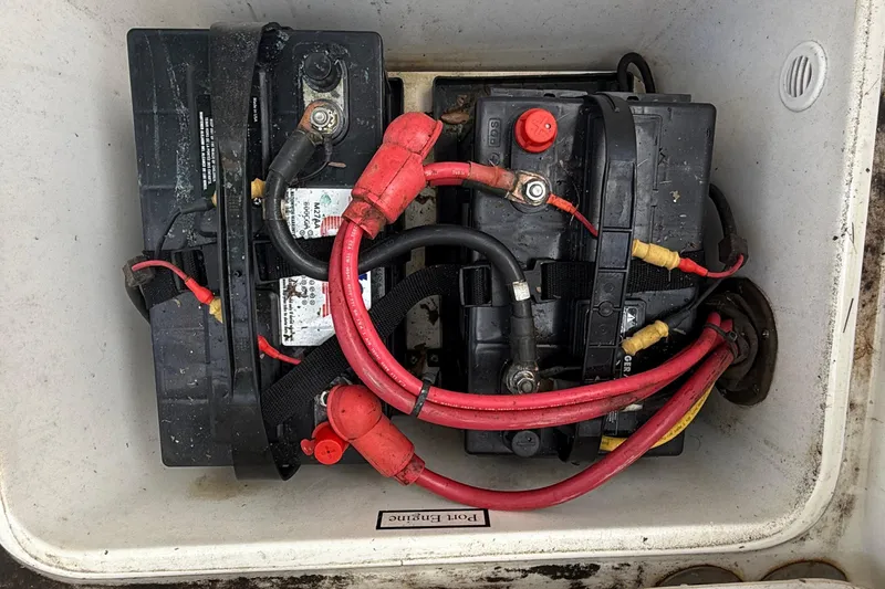 Slide: The Image of Two marine batteries with red and black cables in a 2008 Century 2901 Center Console. - 50