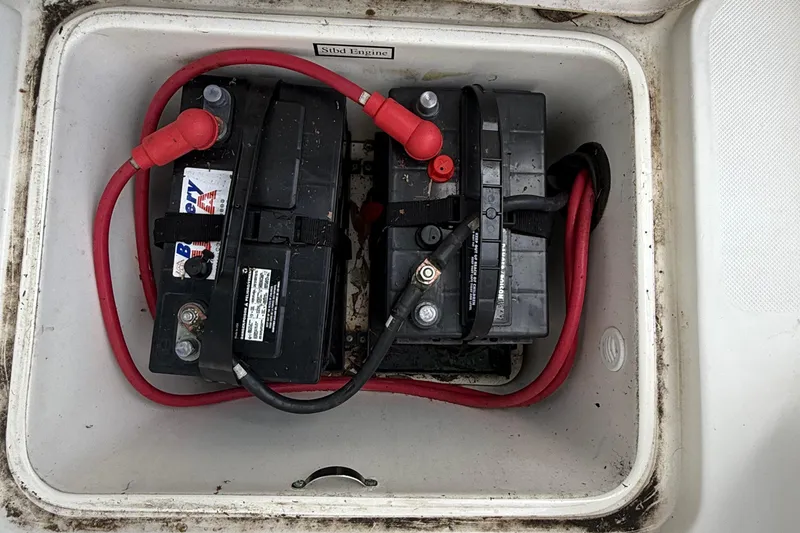 Slide: The Image of Two marine batteries with red cables in a 2008 Century 2901 Center Console boat. - 51