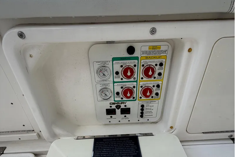 Slide: The Image of Control panel of a 2008 Century 2901 Center Console boat, featuring main and backup switches. - 55