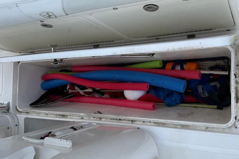 Slide: The Image of Storage compartment of 2008 Century 2901 Center Console filled with colorful pool noodles. - 58
