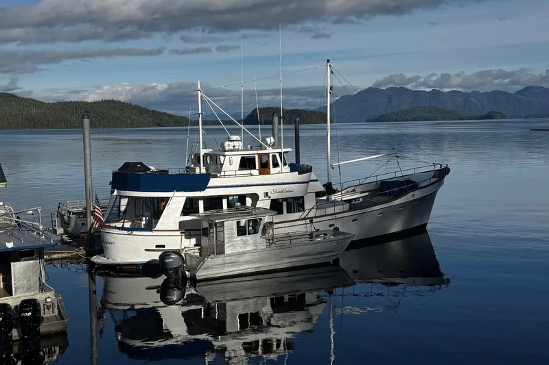 Slide: The Image of 1982 Miller Marine North Sea trawler docked in scenic harbor with mountains. - 1