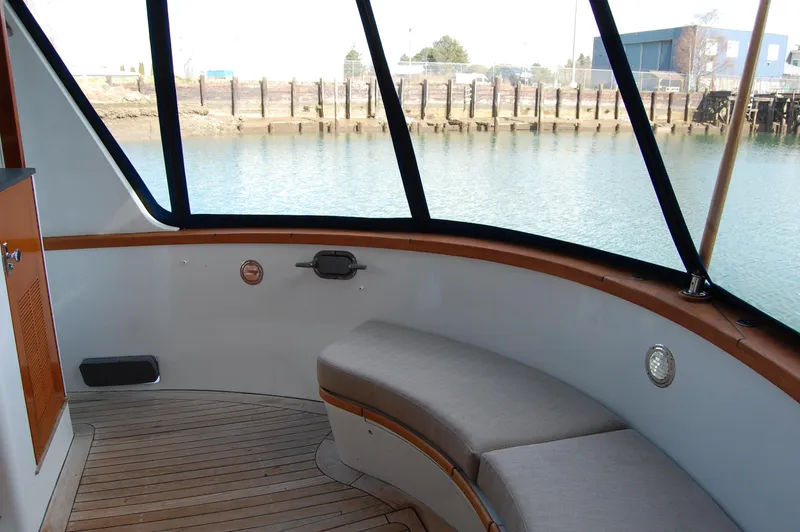 Slide: The Image of 1982 Miller Marine North Sea Trawler interior with curved seating and waterfront view. - 23