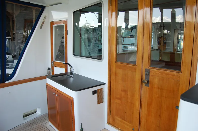 Slide: The Image of 1982 Miller Marine North Sea Trawler with wooden doors and outdoor sink area. - 24