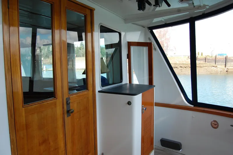 Slide: The Image of 1982 Miller Marine North Sea Trawler interior with wooden doors and large windows. - 25