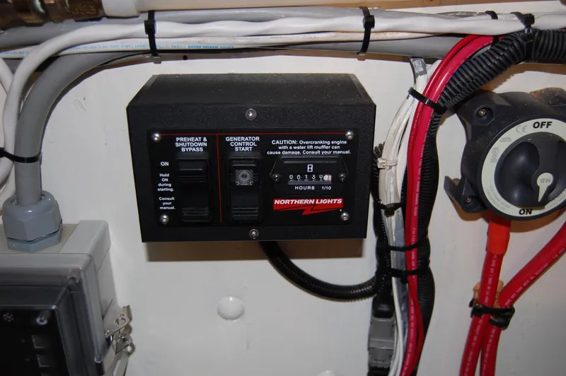 Slide: The Image of Control panel of a 1982 Miller Marine North Sea Trawler, featuring generator controls and wiring. - 27