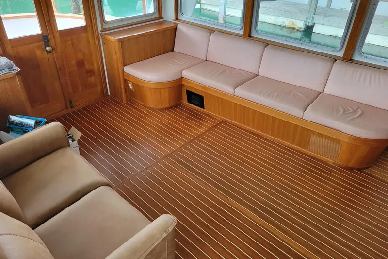 Slide: The Image of Interior of 1982 Miller Marine North Sea Trawler with wooden flooring and beige seating. - 39