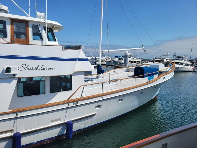 Slide: The Image of 1982 Miller Marine North Sea Trawler docked in a marina under a clear blue sky. - 4